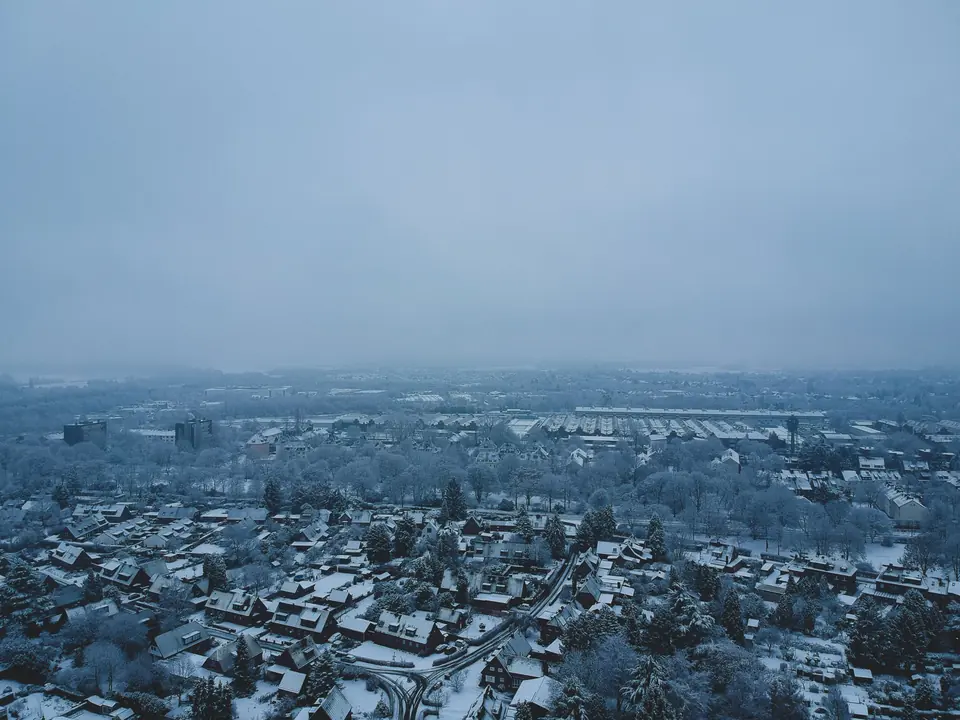 Luftaufnahme eines schneebedeckten Wohngebiets in Krefeld, Deutschland, im Winter.